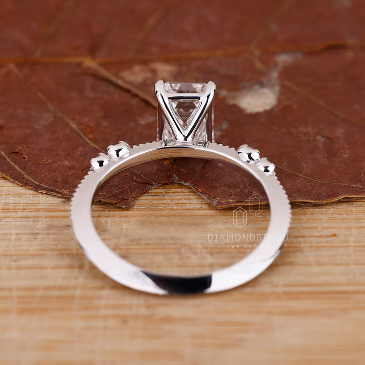 Lab Grown Diamond in emerald cut engagement ring.
