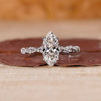 Hidden halo marquise diamond engagement ring in white gold.
