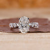 Oval diamond engagement ring with floating bubble prong.
