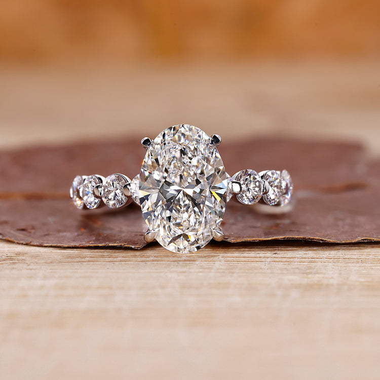 Oval diamond engagement ring with floating bubble prong.
