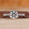 Round diamond engagement ring with pave setting ring.
