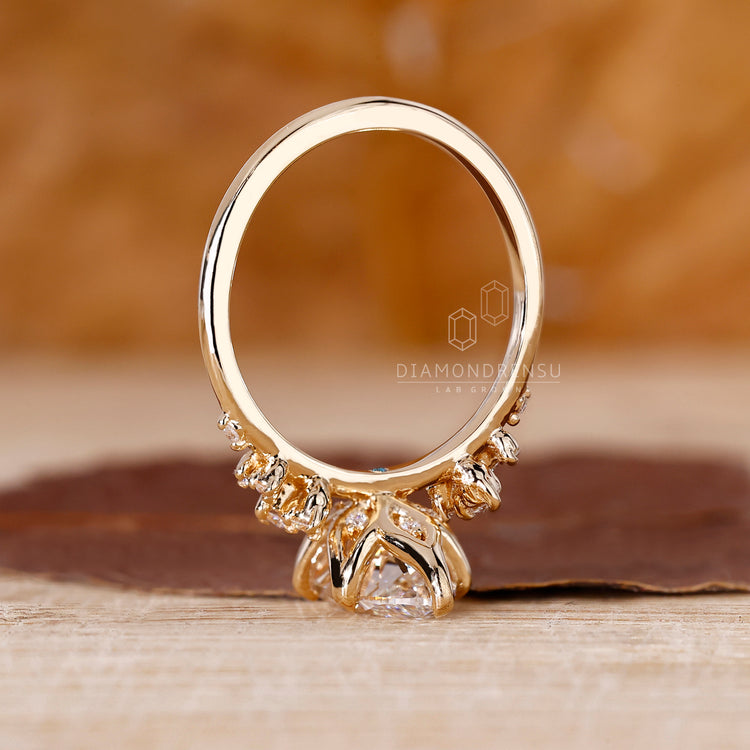 Marquise and round cut diamond cluster ring in yellow gold.
