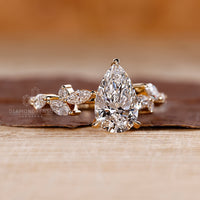 Pear diamond engagement ring has round side stones.
