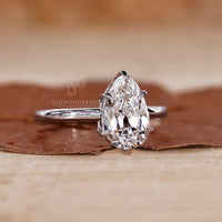 Pear shaped diamond ring designed with IGI certified stones in white gold.
