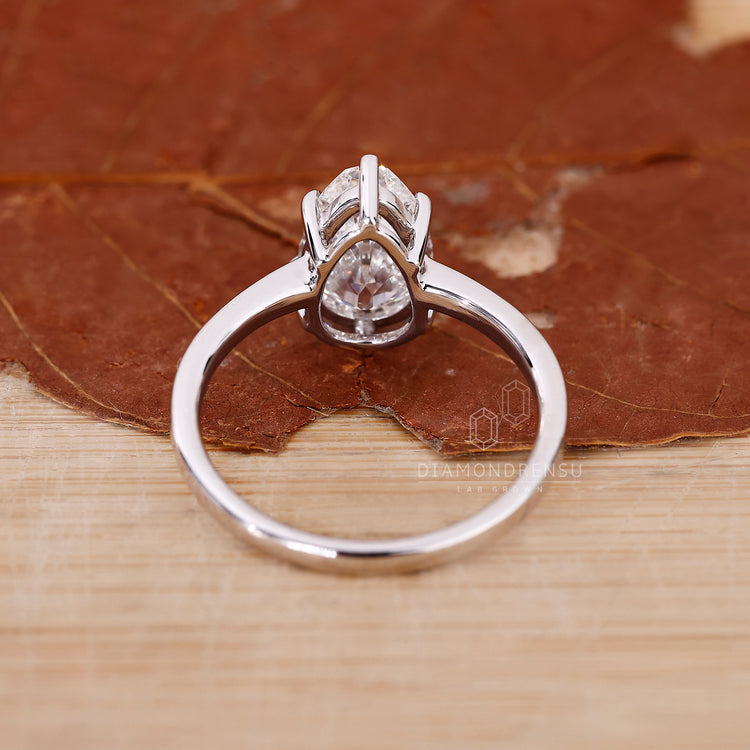 Lab grown diamond solitaire ring with a handcrafted pear shape.
