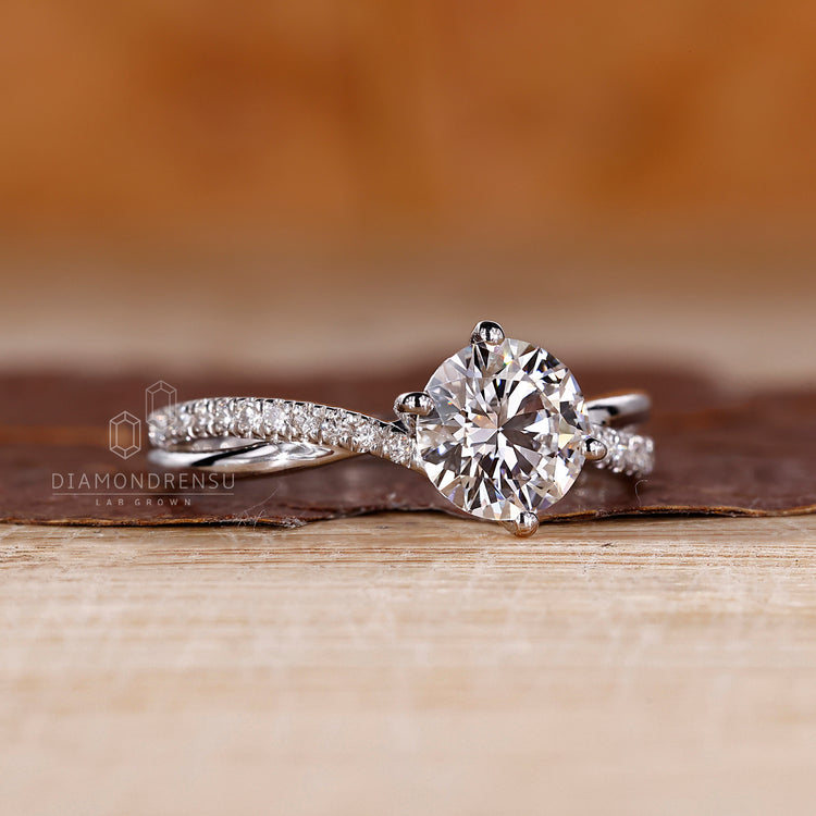 Twisted pave round diamond ring prong setting style.

