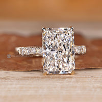 Radiant diamond ring with four claw prong setting.