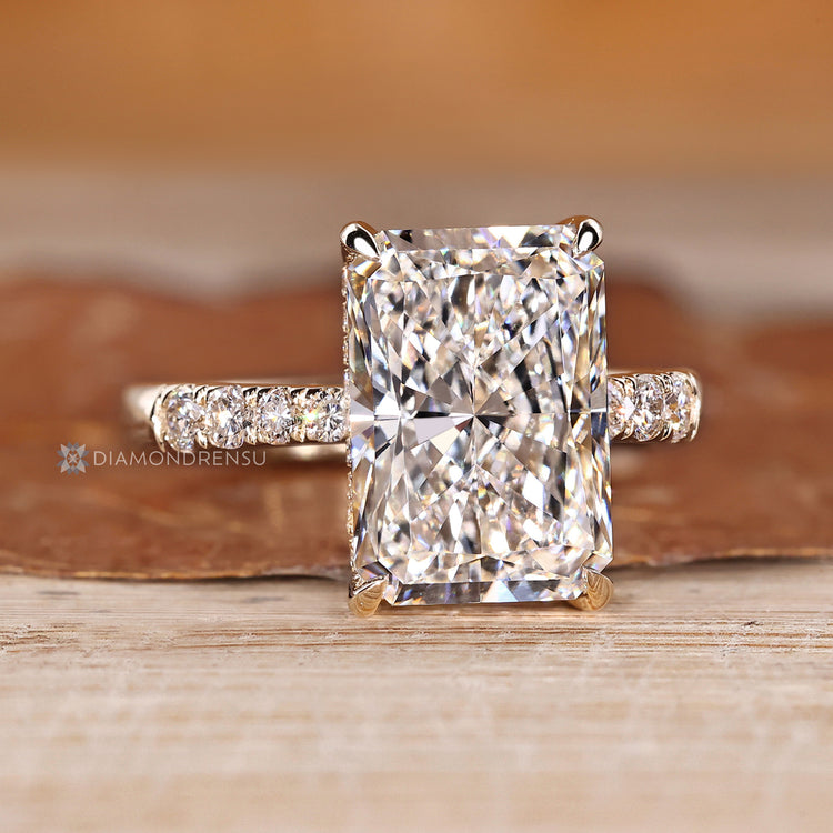 Radiant diamond ring with four claw prong setting.