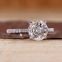 Pave Portuguese cut ring with round diamond setting.
