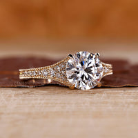 Tapered pave round diamond ring four claw prong set.
