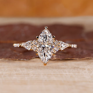 Marquise diamond engagement ring with kite and round side stones.
