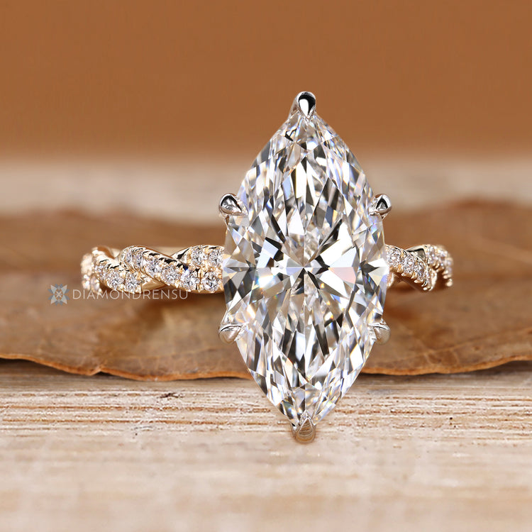Lab grown marquise diamond ring with round diamonds.