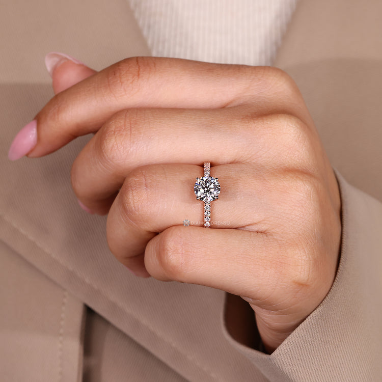 Round cut diamond ring with tulip basket details.