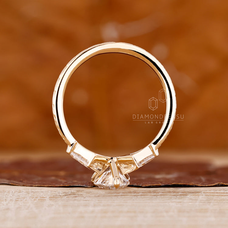 Pear diamond ring three stone kite side stones set.