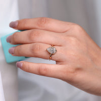 Lab grown pear diamond hidden halo engagement ring.
