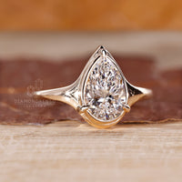 Solitaire pear diamond ring three claw prong set.
