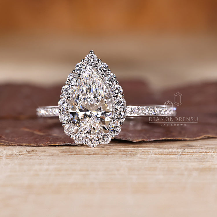 Lab grown pear diamond ring halo pave setting.
