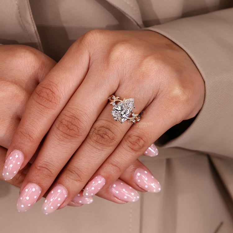 Pear Cut Diamond Ring with round diamond accents.
