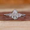 Pear cut diamond ring pear round side stones seven stone.
