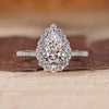 Pear cut diamond ring halo pave three claw prong set.
