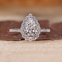 Pear cut diamond ring halo pave three claw prong set.
