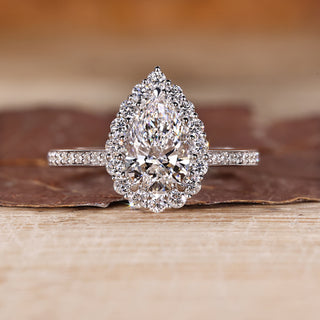 Pear cut diamond ring halo pave three claw prong set.
