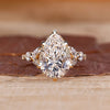 Pear cut diamond engagement ring with round and marquise side stones.
