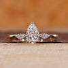 Pear cut diamond ring with marquise cut side stones.
