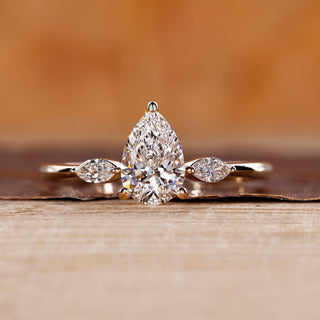 Pear cut diamond ring with marquise cut side stones.
