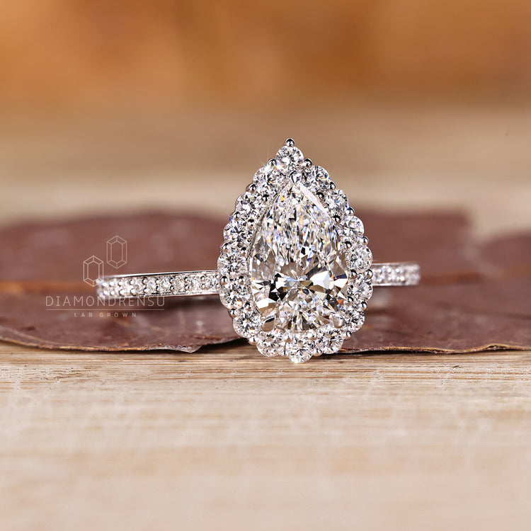 Halo pave pear diamond ring round diamond style.
