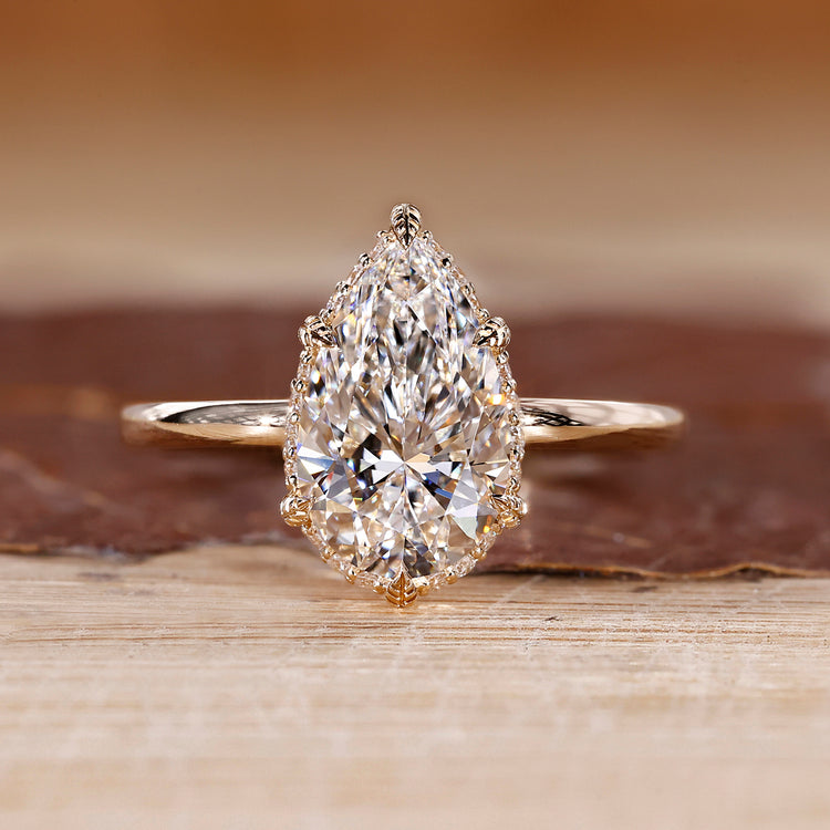 Hidden halo engagement ring with pear cut diamond centre.
