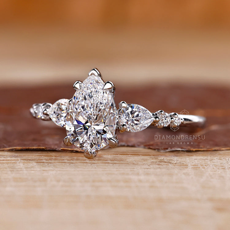 Lab grown pear diamond ring seven stone style.
