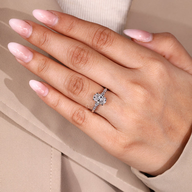 Oval diamond ring cathedral four claw prong setting.
