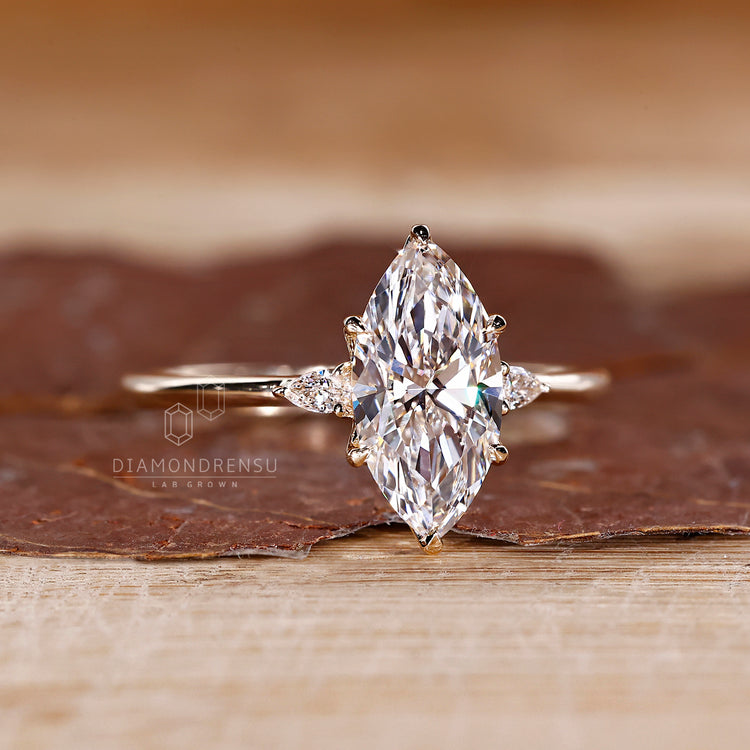 Three stone marquise diamond ring cathedral prong set.

