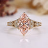 Marquise diamond ring with round side stones.