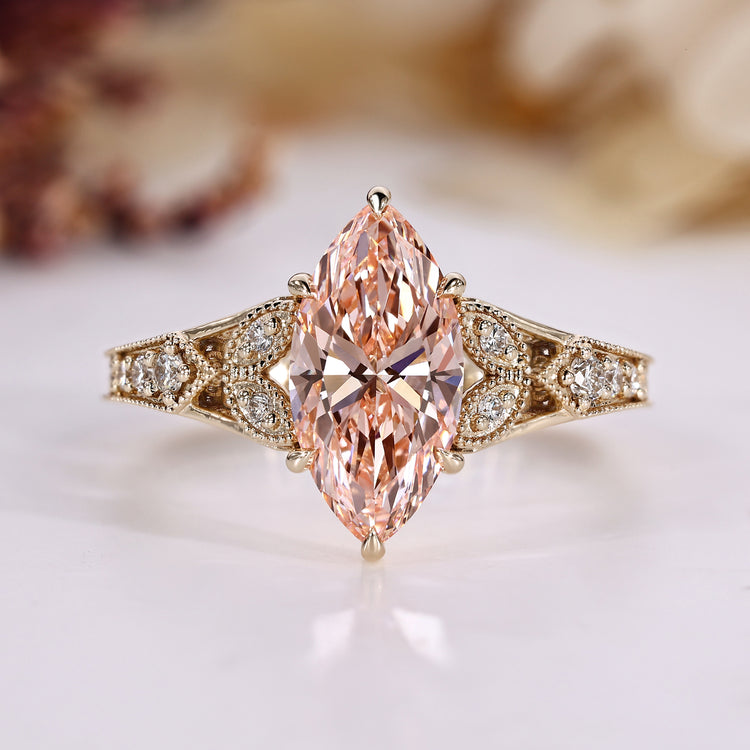 Marquise diamond ring with round side stones.