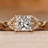 Princess cut diamond ring with round side stones.