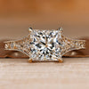 Princess cut diamond ring with round side stones.