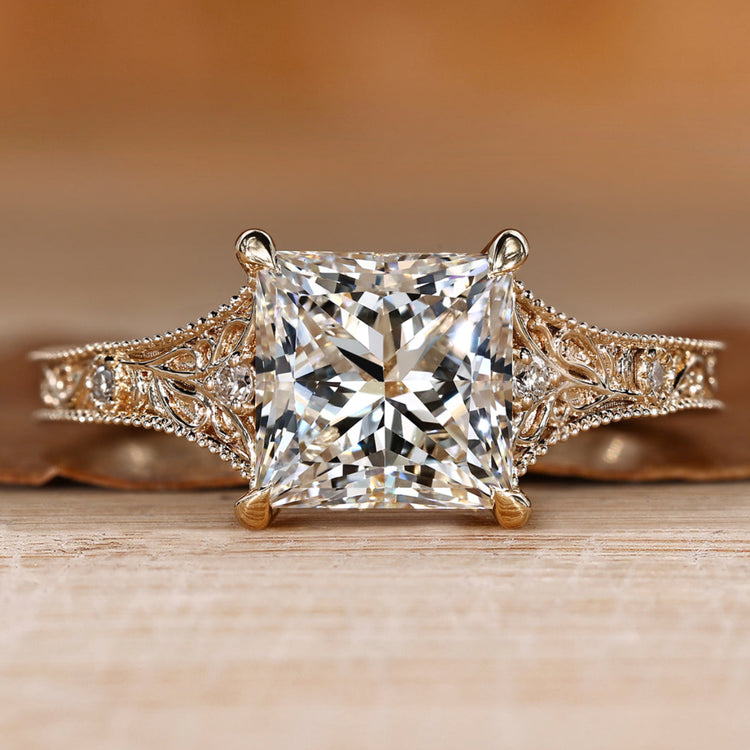 Princess cut diamond ring with round side stones.
