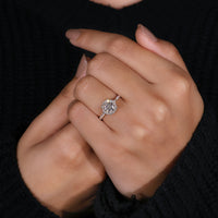 Round cut diamond halo ring set in pave setting ring.
