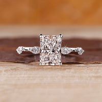 Distance pave hidden halo radiant cut diamond ring.