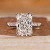 Radiant cut diamond ring with hidden halo and pave style.