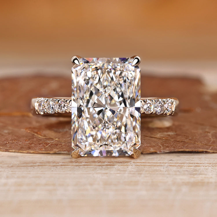 Radiant cut diamond ring with hidden halo and pave style.