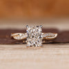 Radiant cut diamond ring with round diamond pave band.
