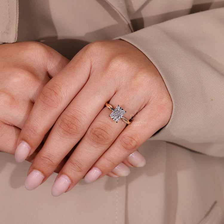 Twisted shank radiant cut diamond solitaire ring.
