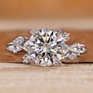 Round diamond ring with marquise and round side stones.