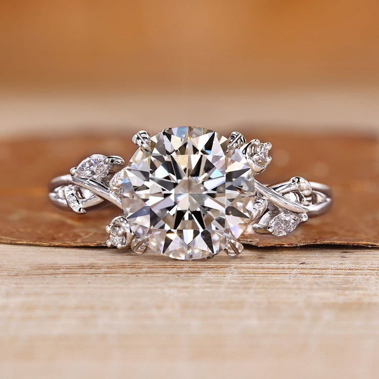 Round diamond ring with marquise and round side stones.