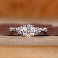 Round cut diamond ring wave split pave shank.