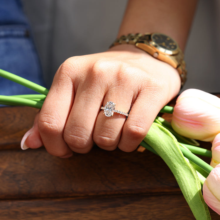 Oval cut ring pave hidden halo four claw prong set.
