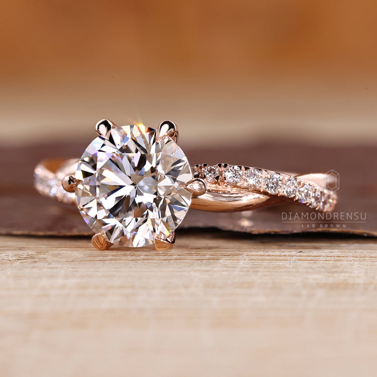 Twisted pave round diamond ring six claw prong set.